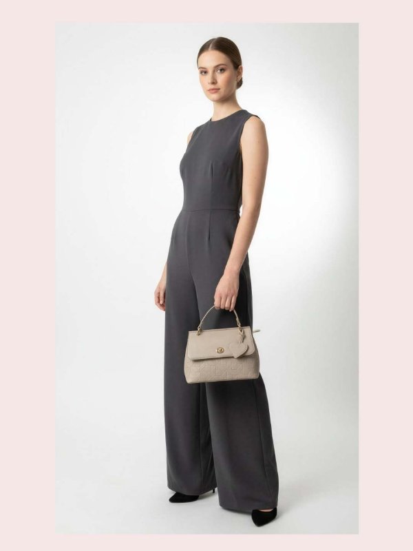 CrossKulture - BlissClass green lightweight handbag carried by female model