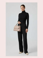 CrossKulture - BlissEase peachlightweight handbag carried by female model