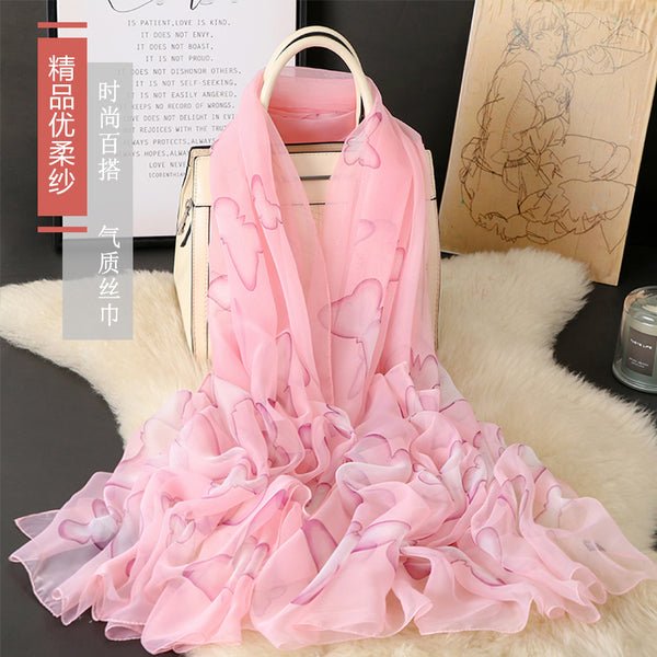 CrossKulture - BlushingWisp Long Chiffon Scarf Pink placed on a bag view