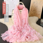 CrossKulture - BlushingWisp Long Chiffon Scarf Pink placed on a bag view