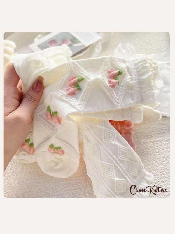 CrossKulture - SoleBesties pink & White crew socks in hand model view