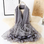 CrossKulture - DarkDrift Long Chiffon Scarf Grey placed on a bag view
