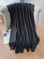 CrossKulture - CarbonBlack viscose scarf in black on sofa
