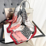 CrossKulture - GlossyPop Small Square Satin Scarf Red placed on a bag view