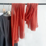 CrossKulture - RustTint Rust Crinkled Cotton Scarf hanging on a handle view