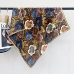 CrossKulture - WovenWhispers Herringbone Weave Small Square Scarf hanging on a handle bar