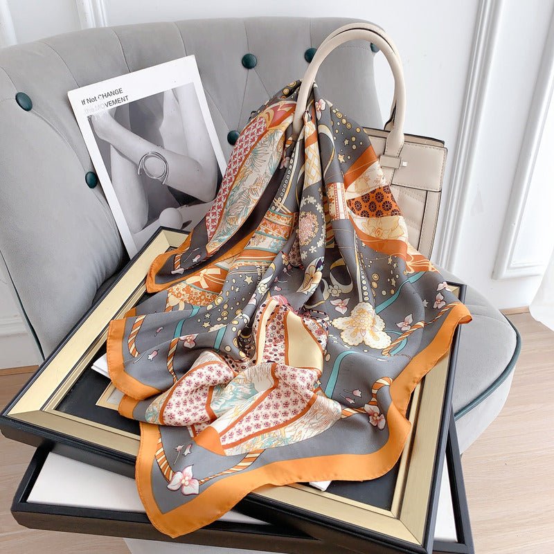 CrossKulture - SmokyBlaze Small Square Satin Scarf Orange placed on a bag view