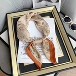 CrossKulture - HazelnutBloom Small Square Satin Scarf Beige knot style on frame view