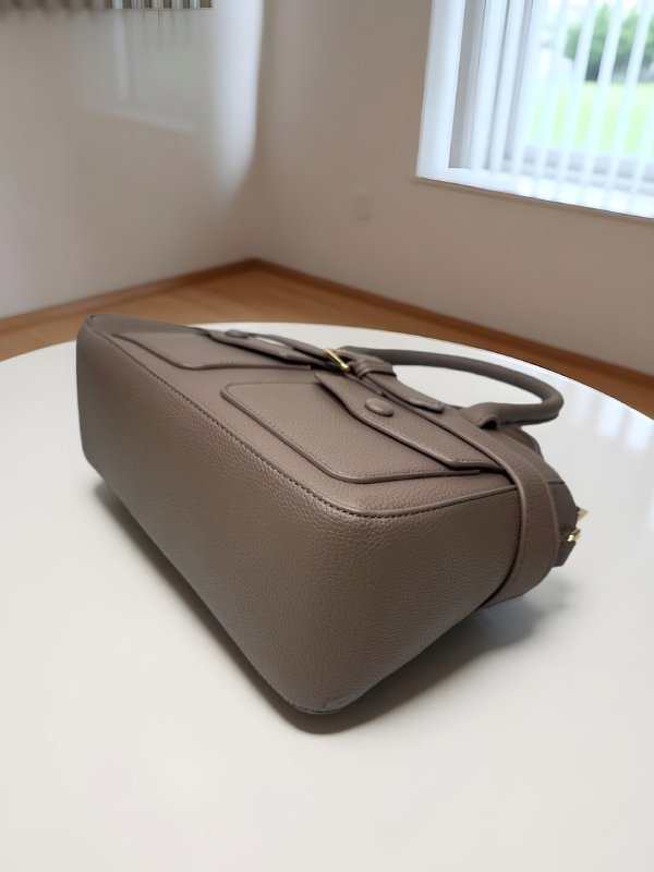 CrossKulture - BlissIcon harm two front pocket beige handbag placed on a table