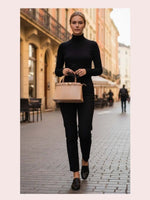 CrossKulture - BlissGlow beige lightweight handbag carried by female model