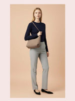 CrossKulture - BlissAllure grey lightweight handbag carried by female model