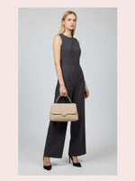 CrossKulture - BlissDelight beige lightweight handbag carried by female model
