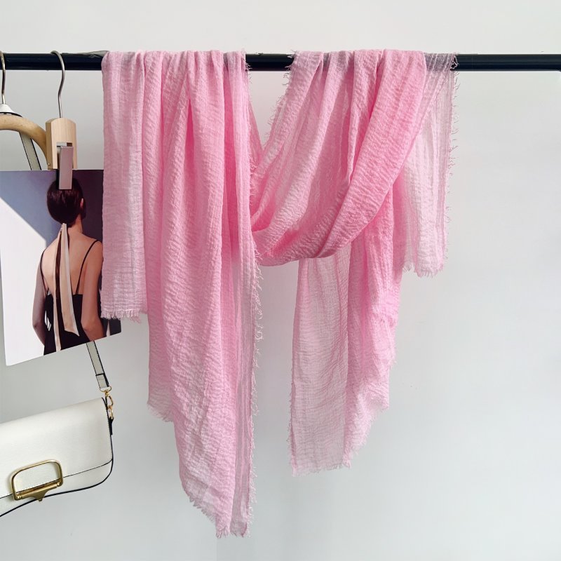 CrossKulture - BlushWhisper pink crinkle scarf hanging on a handle bar