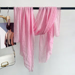 CrossKulture - BlushWhisper pink crinkle scarf hanging on a handle bar