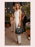 CrossKulture - BlissNoir black lightweight handbag carried by female model