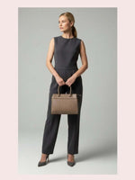 CrossKulture - BlissCarry green lightweight handbag carried by female model
