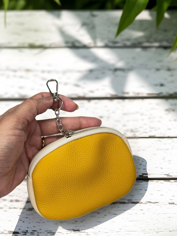 CrossKulture - GlamPouch lightweight coin purse front view with model hand
