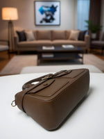 CrossKulture - BlissCharm two front pocket brown handbag placed on a table