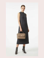 CrossKulture - BlissTrend green lightweight handbag carried by female model